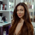 Beautiful brunette woman with long and shiny hair at beauty salon