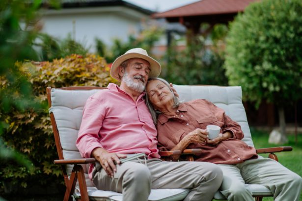 Happy couple relaxing together in their garden.